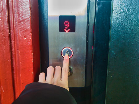 Person Pressing Elevator Button in Budapest Ors vezer tere Panelhaz