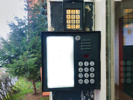 Close-up of a digital entry system on a panel building in Budapest. Features two numeric keypads and...