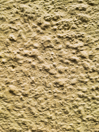 A detailed view of a yellow wall featuring faint horizontal textural lines. This abstract composition offers a unique, structured background for modern or artistic projects.の写真素材