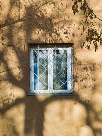 A minimalist architectural study of a window on Ecseri ut in Budapest. Features warm morning...
