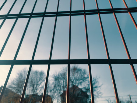A high-quality commercial photo of a red metal fence in Budapest. Capturing a geometric grid pattern...