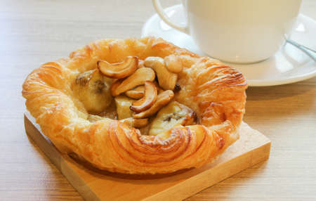 banana pie on wood and a cupの写真素材