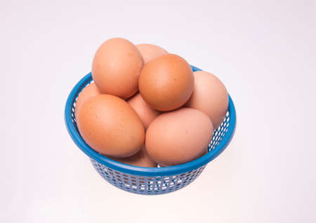 egg on blue basket isolated white backgroundの写真素材