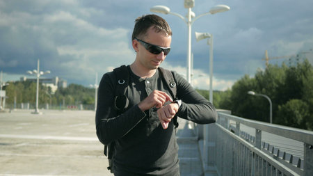A man walks down the street stops because of the message on the smart watch. He dictated a message...