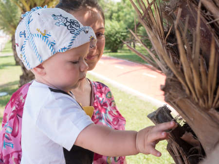 Happy mother with cute baby boy having tropical vacation on Maldives. Kid playing among palm trees.の写真素材