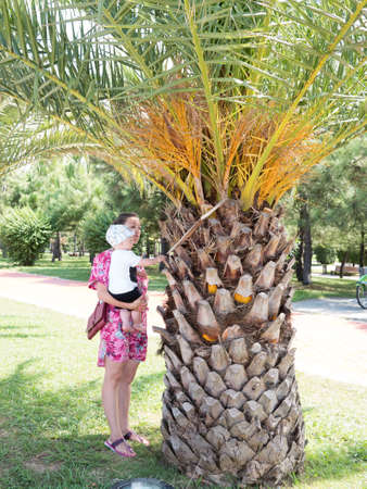 Happy mother with cute baby boy having tropical vacation on Maldives. Kid playing among palm trees.の写真素材