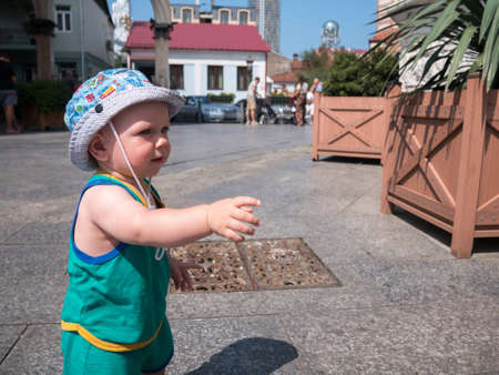 Young mother with her toddler son playing outdoors in city.の写真素材