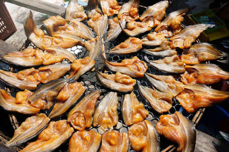 Salted fish is a dry food. . Fish marinated in salty  sauce and dried in the sun to preserve food ,Thai style.Close up and top view.の写真素材