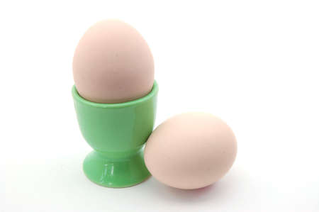 two egg in a eggcup isolated on white backroundの写真素材