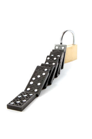 some dominos and a padlock for security isolated on white backgroundの写真素材