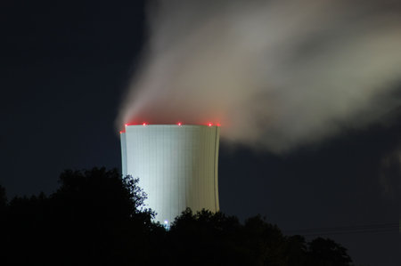 a smoking industrial power plant at night