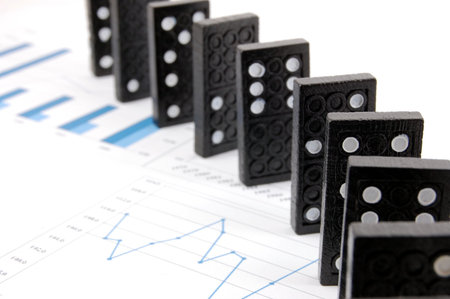 some domino stones on a blue  business chart の写真素材