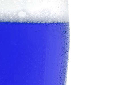 colored drink with foam isolated on white backgroundの写真素材