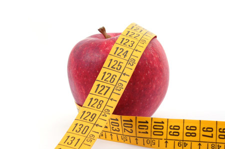 apple and measuring tape isolated on white background