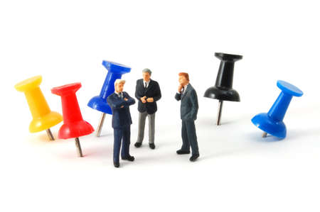 business man and push pin in a office isolated on white backgroundの写真素材