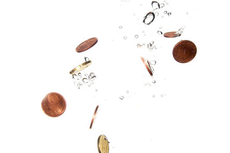 money in water with bubbles on white background