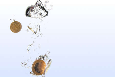 money in water with bubbles on white backgroundの写真素材