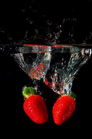 strawberrys splashing in fresh water showing healthy lifestyleの写真素材