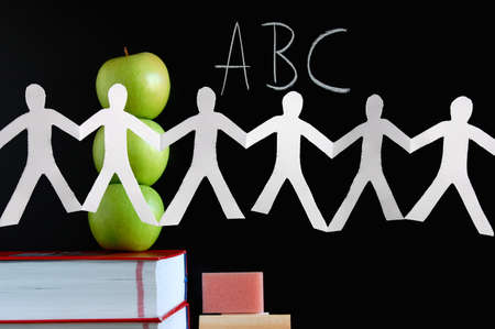 blackboard with apples and books showing a concept for educationの写真素材