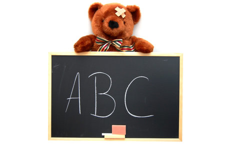 teddy with blackboard isolated on white backgroundの写真素材