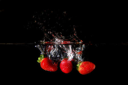 strawberrys splashing in fresh water showing healthy lifestyleの写真素材