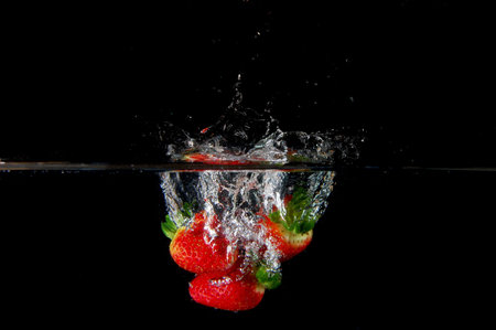 strawberrys splashing in fresh water showing healthy lifestyleの写真素材
