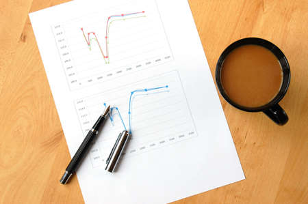 business still life with coffee and chart showing success の写真素材