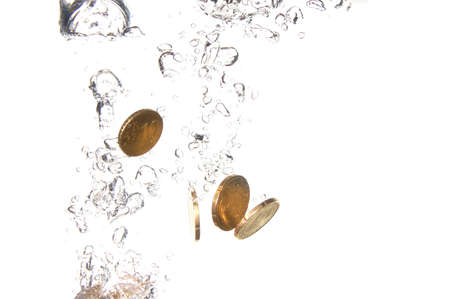 money in water with bubbles on white backgroundの写真素材