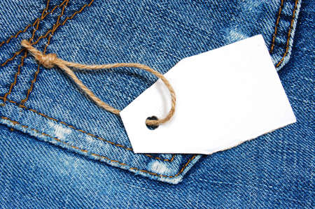 blank price tag with copyspace on a jeans textureの写真素材