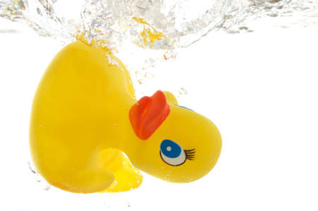 rubber duck in bath bathroom splashing in waterの写真素材
