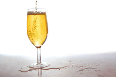 glass of fresh beer with bubbles on whiteの写真素材