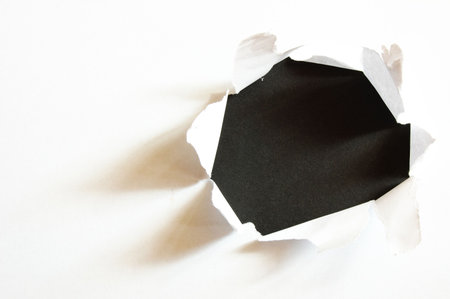 black hole in white paper with copyspaceの写真素材