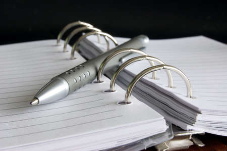 business organizer or pocket planner with pen for busy peopleの写真素材