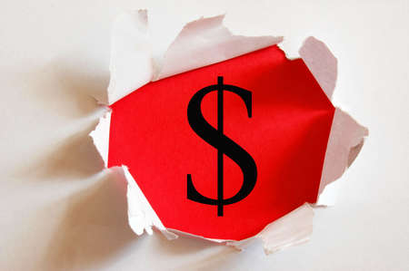 money hole in paper and red backgroundの写真素材