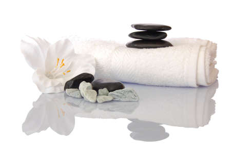 wellness zen and spa still life with flower towel and pebbles isolated on whiteの写真素材