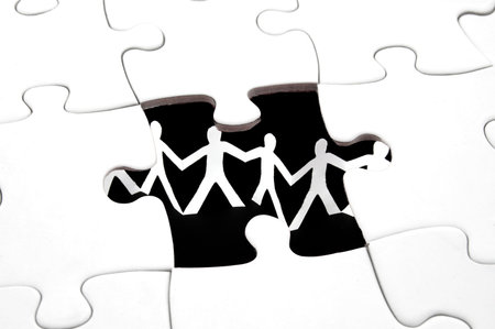 puzzle and paper man team showing teamwork concept                                    