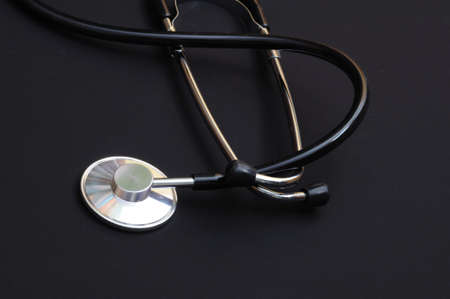 stethoscope on a black background showing health or medical conceptの写真素材