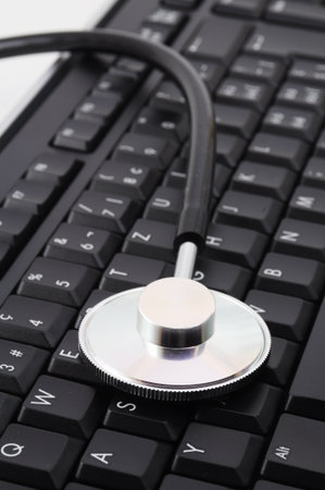 stethoscope on keyboard showing computer problem concept