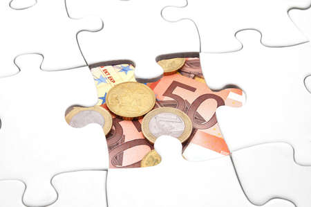 puzzle and money showing business or finance concept                                    の写真素材