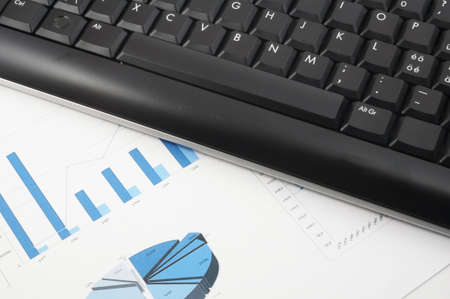 keyboard and paper on a desk in the officeの写真素材