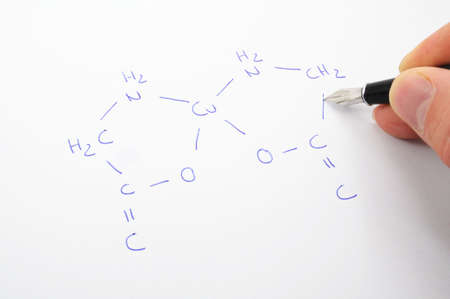 chemical formula with hand and pan ob sheet of paperの写真素材