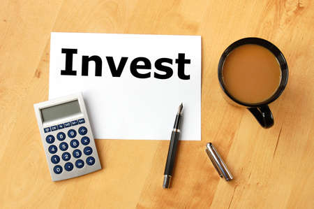 investment business concept with pen paper and cup of coffeeの写真素材