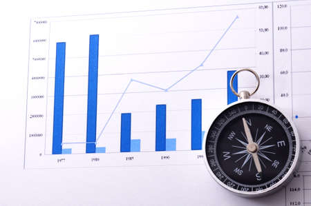 business navigation concept with compass and diagram or graphの写真素材