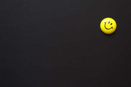 copyspace on a blackboard with yellow smiley for a happy or lucky dayの写真素材
