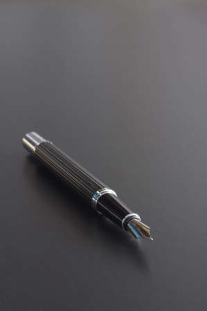 pen showing communication contact us or mail concept on black backgroundの写真素材
