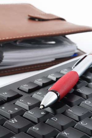 computer keyboard and organizer with pan in business officeの写真素材