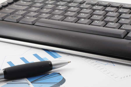 keyboard and paper on a desk in the officeの写真素材