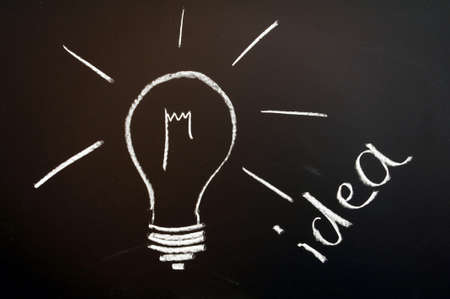 bulb on chalkboard showing idea creativity and innovation                              の写真素材