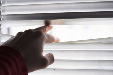 spy or observation concept with window and handの写真素材