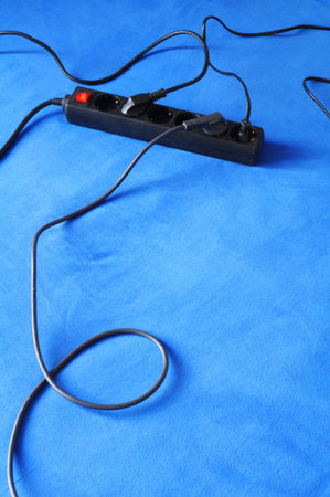 power plug and blue copyspace showing energy saving conceptの写真素材